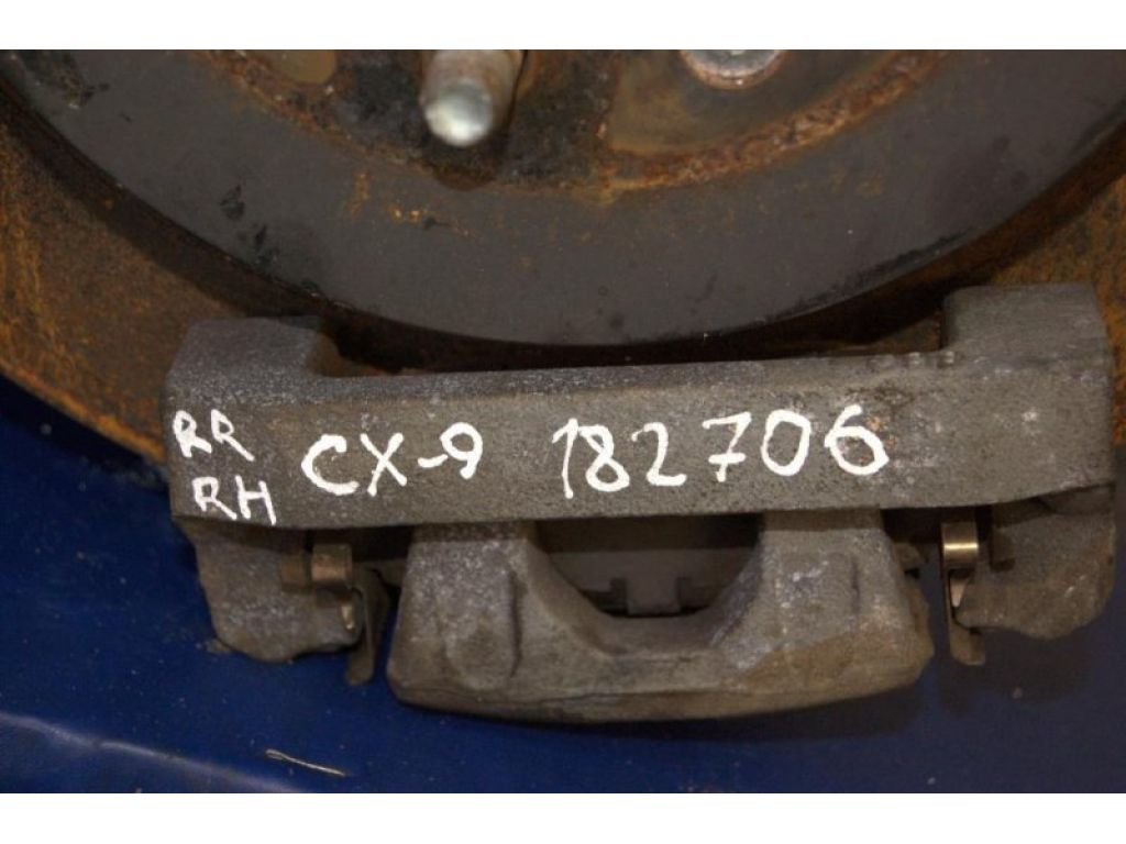 L2Z2-26-99ZA | Суппорт тормозной задн. лев. MAZDA CX-9 06-16